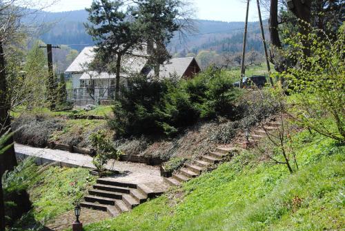 a set of stairs on a hill with a house at Wilinianka in Pieszyce