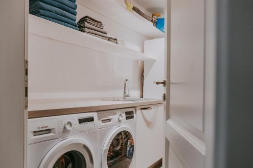 a laundry room with a washer and dryer at Exceptional 5 Star villa with breathtaking views, Sauna and fitness studio in Momjan
