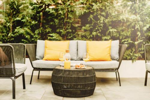 a patio with chairs and a table with a bottle of orange juice at Exceptional 5 Star villa with breathtaking views, Sauna and fitness studio in Momjan