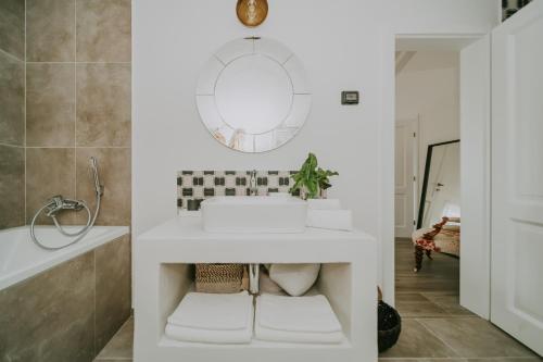 a bathroom with a sink and a mirror at Exceptional 5 Star villa with breathtaking views, Sauna and fitness studio in Momjan