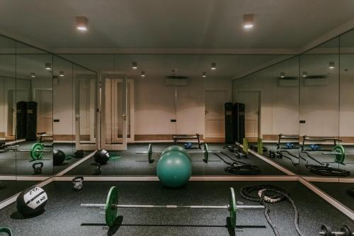 a gym with mirrors and a lot of exercise equipment at Exceptional 5 Star villa with breathtaking views, Sauna and fitness studio in Momjan