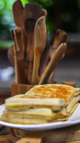 a stack of pancakes on a plate on a table at La Bicok EcoLodge in Mindo