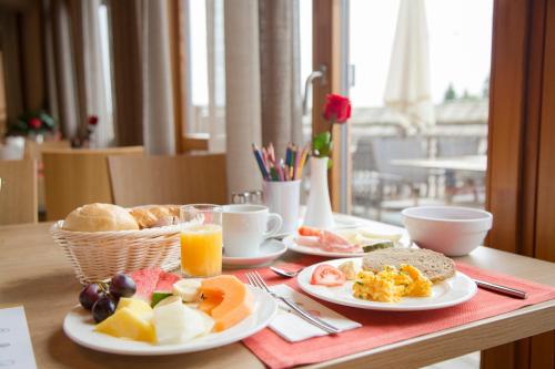 a breakfast table with plates of food and drinks at RAMSI euer Familienhotel in Hermagor