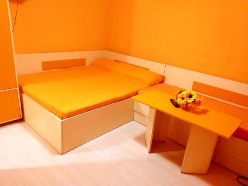 a small room with two beds and a table at APART-JULY in Varna City