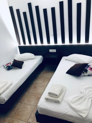 two beds sitting next to each other in a room at Villa Livadaros in Karterados