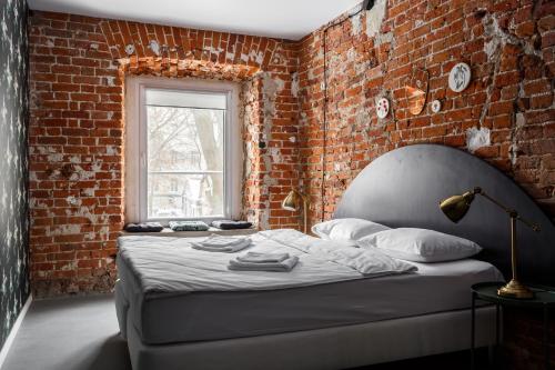 a bedroom with a bed and a window at Strawberry Duck Moscow in Moscow