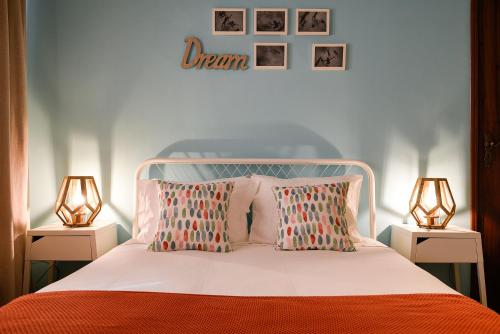 a bedroom with a white bed with two lamps at The Sea Beach House in Cortegaça