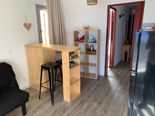 a kitchen with a wooden table and a refrigerator at Appartement de vacances à Isola 2000 in Isola 2000