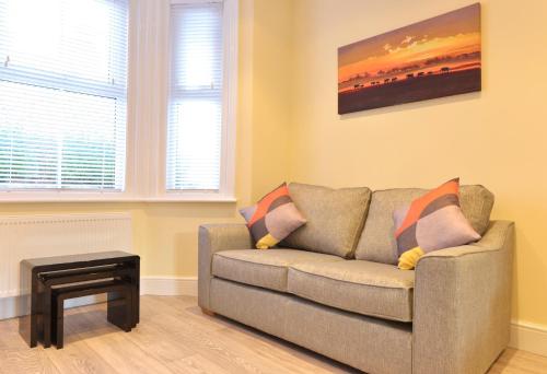 a living room with a couch and a table at St Mary's Cottage in Eastbourne