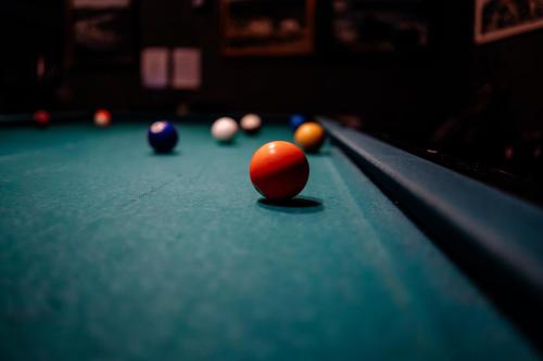 a snooker ball on the edge of a pool table at Hotel Laxnes in Mosfellsbær