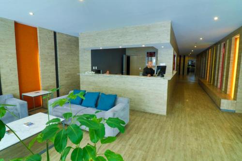 a living room with a couch and a bar at Mallorca Hotel  in Mexico City
