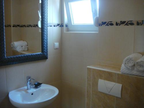 a bathroom with a sink and a mirror at Apartments Holiday in Split