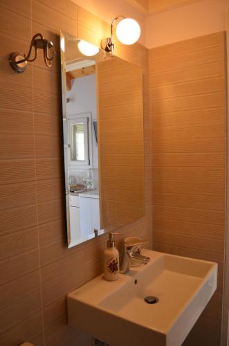 a bathroom with a sink and a mirror at Romanza Studios in Asos