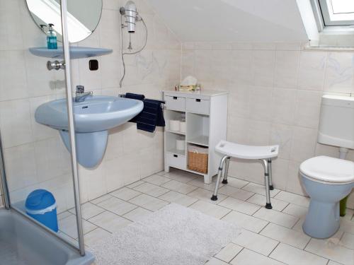 a small bathroom with a sink and a toilet at Ferienwohnung Schillinger in Sasbach am Kaiserstuhl