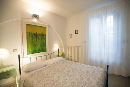 a bedroom with a bed and a painting on the wall at B&B Aquilone in Urbino