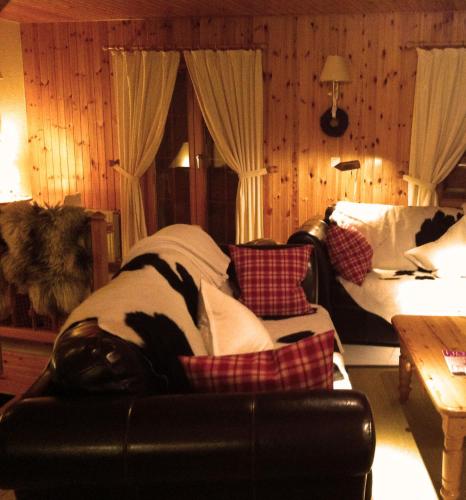 a living room with a couch and a bed at Chalet Michele Alpage in Les Collons