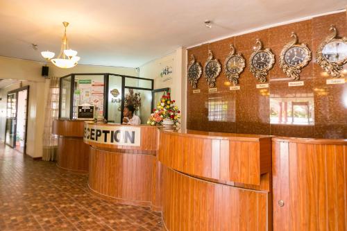 a restaurant with wooden counters and plates on the wall at Fahari Gardens Hotel in Nairobi