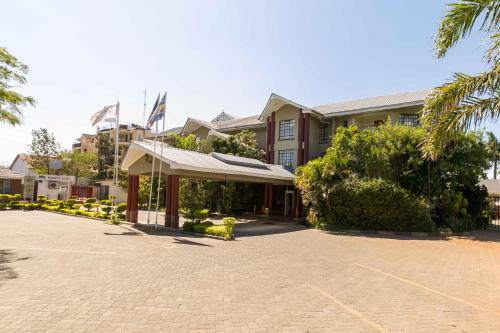 a building with a parking lot in front of it at Fahari Gardens Hotel in Nairobi