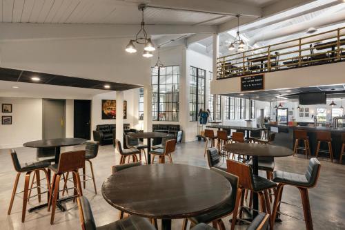 a group of tables and chairs in a restaurant at enVision Hotel Miami International Airport in Miami