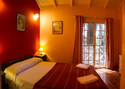 a bedroom with a bed and a large window at Cabañas MARE PARADISO in Costa del Este