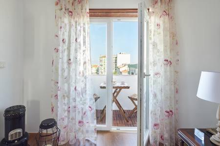 a room with a window with a view of a balcony at Seven Guest House in Falagueira