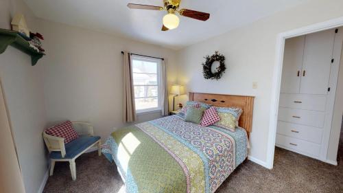 a bedroom with a bed and a ceiling fan at Wisteria Vine Cottage in Monticello