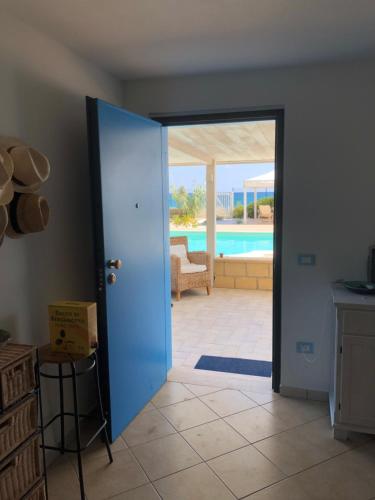 an open door to a living room with a pool at GIGLIO DI MARE Residence in Sellia Marina