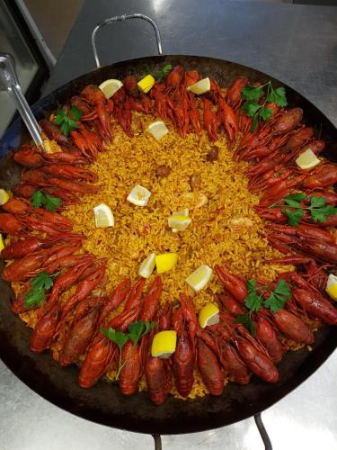 a large plate of food with sausage and rice at Furuliden Country Inn in Vittsjö