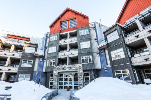 an apartment building with snow in front of it at Lake Placid Lodge by Whiski Jack in Whistler