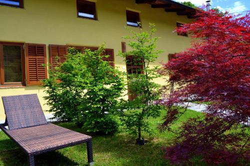 a bench sitting in the grass next to a building at Počitniška hiša Lazar in Kobarid
