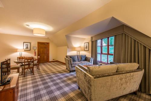 a living room with a couch and a table at Murrayshall Country Estate in Perth
