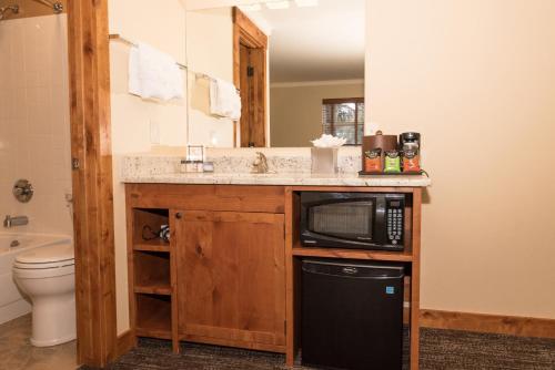 a bathroom with a sink and a microwave at The Maxwell Inn in Estes Park