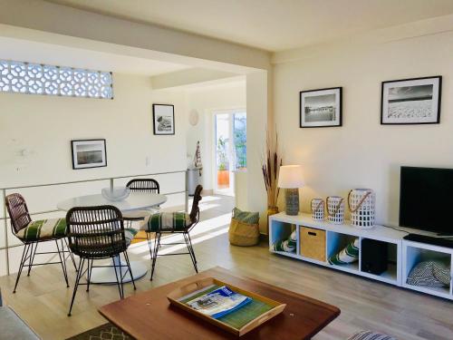 a living room with a table and a television at Casa Do Gilao in Tavira