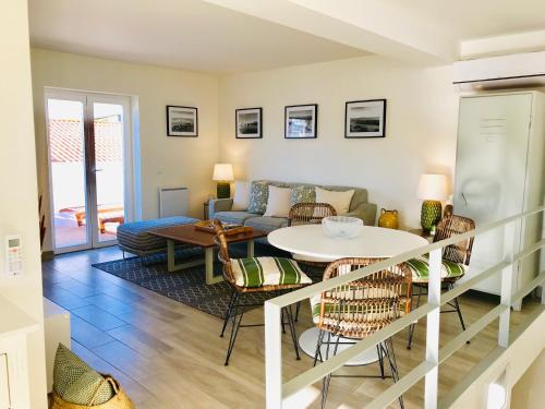 a living room with a couch and a table at Casa Do Gilao in Tavira