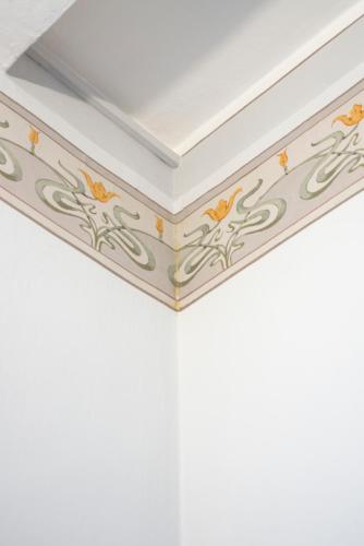 a white ceiling with orange and yellow flowers on it at B&B Aquilone in Urbino