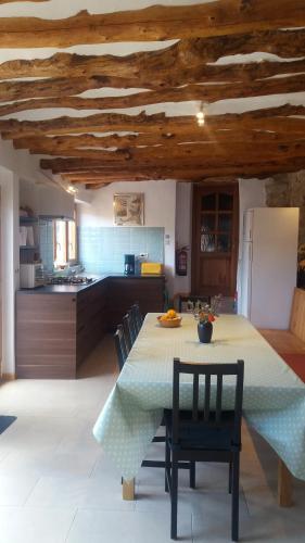 a kitchen with a table and chairs in a kitchen at Corral De La Solana in Molinos