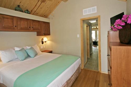 a bedroom with a large bed and a hallway at Live Oak Landing in Freeport