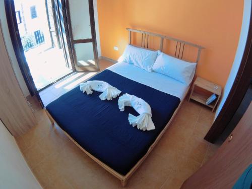 a bedroom with a bed with two pillows on it at KiteHouse LaPalma in Birgi Vecchi