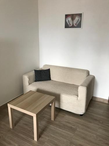 a living room with a couch and a coffee table at Ubytování U Valašských ponožek in Hovězí