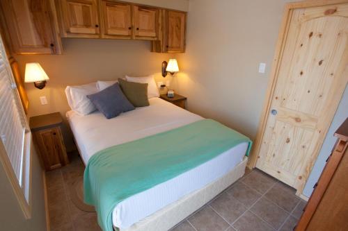 a small bedroom with a bed and a door at Catherine's Landing RV Resort in Hot Springs