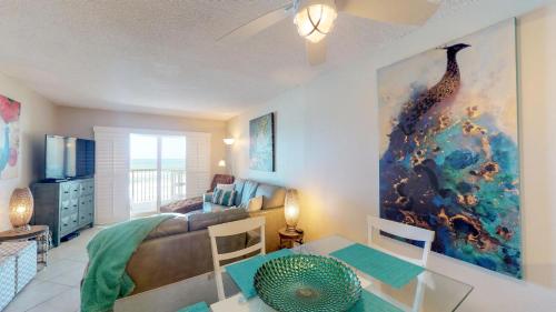 a living room with a couch and a table at Point East in New Smyrna Beach