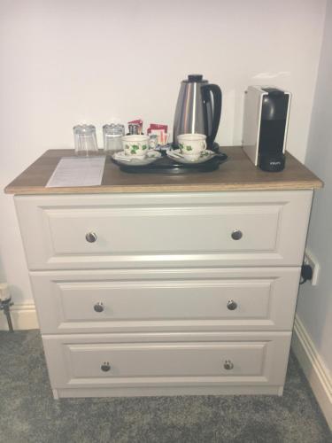 a white dresser with a coffee maker on top of it at St. Catherines in Doolin