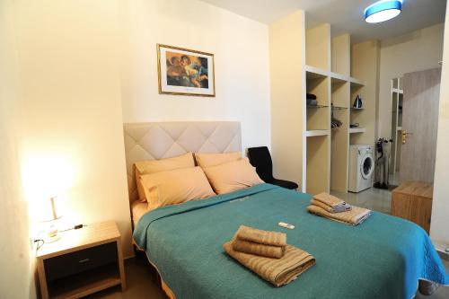 a bedroom with a bed with two towels on it at Thalia Premium Apartment in Kavála