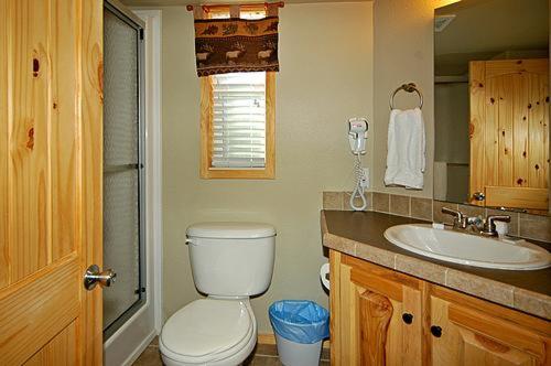 a bathroom with a toilet and a sink at Catherine's Landing RV Resort in Hot Springs