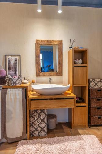 a bathroom with a sink and a mirror at Casa Maddalena in Vicoforte