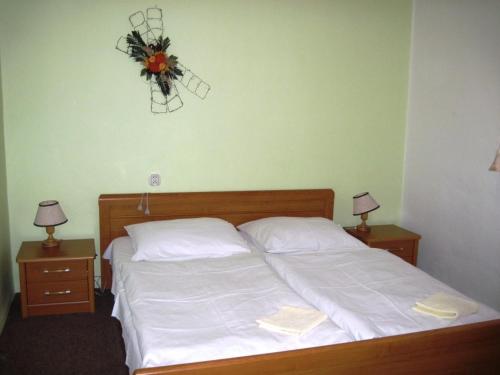 a bedroom with a bed with a wreath on the wall at Pension Palla - self check-in in Svojanov