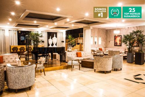a lobby with a piano and tables and chairs at Oro Verde Cuenca in Cuenca