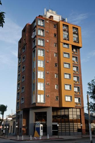 a tall brick building on a city street at Hotel Tres Cruces in Montevideo