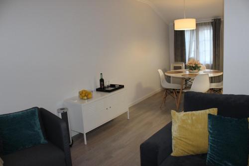 a living room with a couch and a table at Vigia's Guest House in Viseu