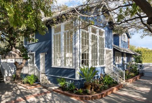 a blue house with plants in front of it at Hideaway Santa Barbara, A Kirkwood Collection Hotel in Santa Barbara